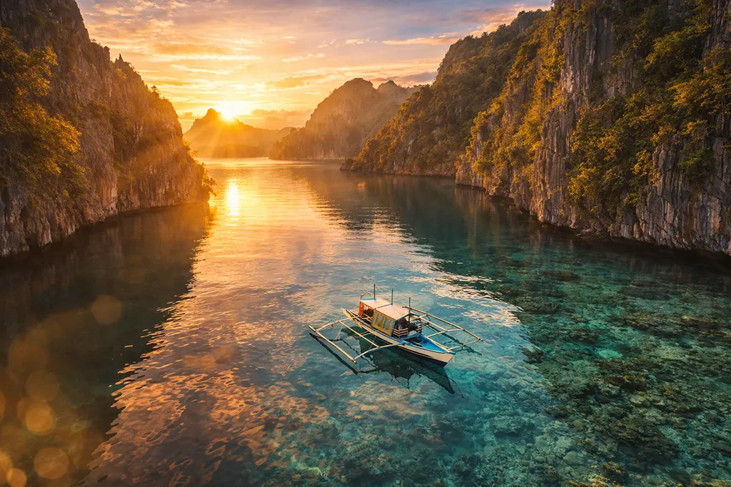 Aerial view of El Nido Palawan limestone cliffs and turquoise lagoon at sunset Philippines